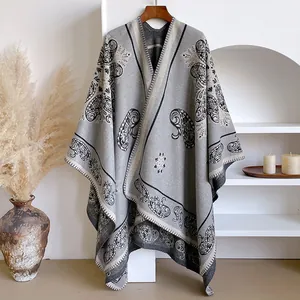 Detail of grey vintage cashmere-like poncho featuring intricate paisley embroidery patterns