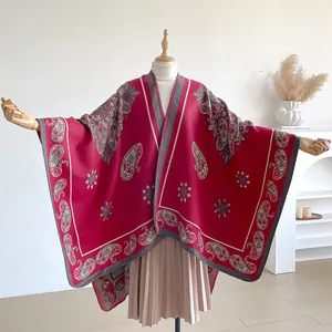 Detail of red paisley jacquard pattern and thick cashmere-like texture on retro poncho