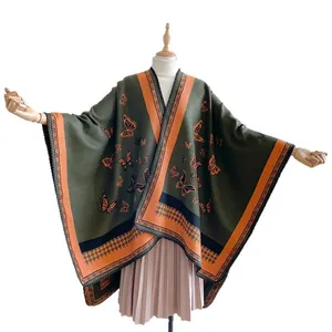 Ethnic cashmere-like shawl featuring orange butterfly patterns and houndstooth trim details