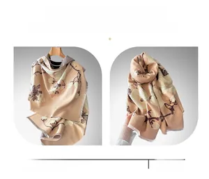 Detail of winter scarf showing magnolia jacquard patterns and soft tassel edges
