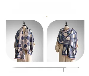 Detail of blue and beige polka dot scarf showing shawl and wrap styling on mannequin