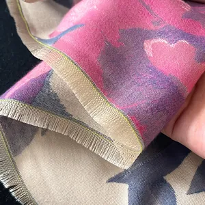Elegant cashmere-like scarf with abstract floral ink patterns and soft fringe detail