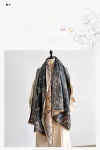 Detailed view of thick paisley pattern scarf with soft cashmere-like texture in dark grey