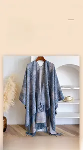 Detail of blue Paisley shawl featuring elegant fringe trim and soft ethnic pattern