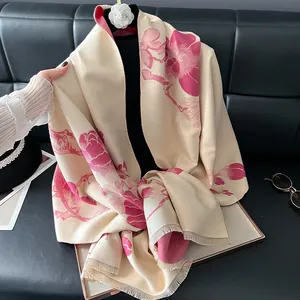 Detail of floral plum blossom pashmina scarf with elegant fringe and cashmere texture