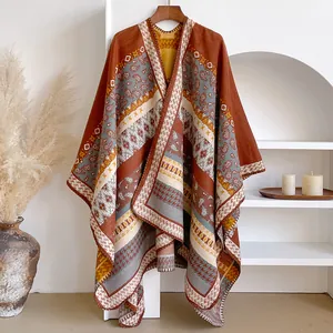 Detailed view of bohemian paisley jacquard patterns on thick warm winter poncho shawl