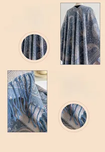 Macro view of blue paisley pattern pashmina with fringed hem and thick woven texture