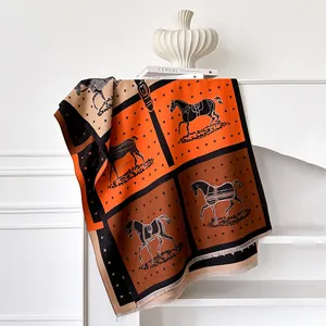Classic horse and cross pattern scarf in orange and brown with elegant fringe detail