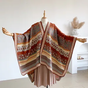 Detail of bohemian knit shawl featuring ethnic paisley patterns and thick warm fabric