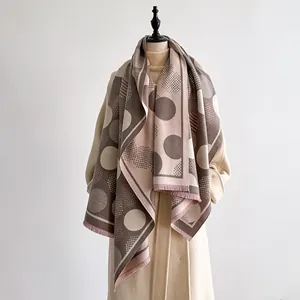 Detail of earthy geometric dot pattern on thick cashmere-like scarf with fringe