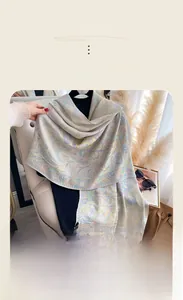 Close-up of imitation cashmere scarf with paisley pattern and delicate fringe edge