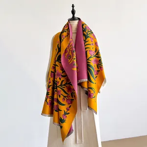 Close-up of double-sided floral scarf in ginger yellow and rose pink cashmere-feel