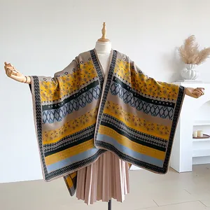 Detail of bohemian knit shawl with geometric paisley patterns and woven edge on a mannequin