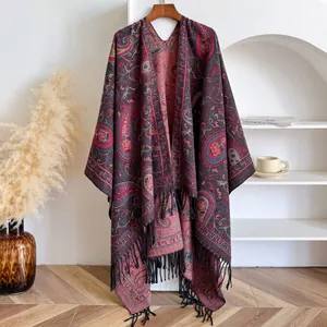 Detail of ethnic paisley shawl featuring vibrant patterns and elegant black fringe tassels