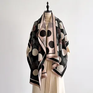 Close-up of geometric dot pattern and tassel fringe on cashmere-like shawl scarf