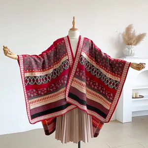 Close-up of bohemian geometric knit pattern on thick warm ethnic style poncho