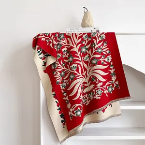 Detail of red floral cashmere-feel scarf featuring vintage jacquard pattern and fringes