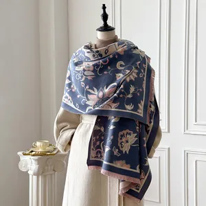 Detailed view of ethnic floral jacquard scarf fabric with fringe edge on beige coat