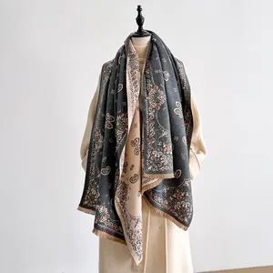 Close-up of vintage paisley printed scarf with thick wool-like texture and tassel fringe