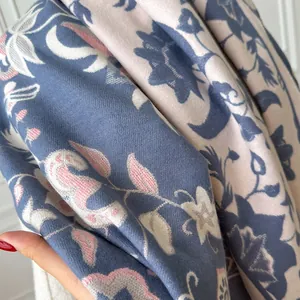 Macro detail of floral jacquard pattern on blue and beige pashmina scarf shawl