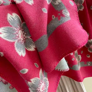 Detailed macro view of bohemian floral pashmina fabric showing thick cashmere-like texture