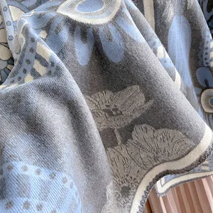 Detailed view of bohemian jacquard fabric with grey-blue floral patterns and soft texture