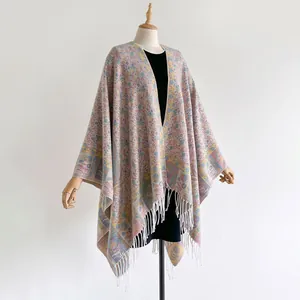 Close-up of bohemian floral jacquard patterns and delicate white fringe on the scarf