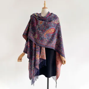 Close-up of ethnic purple cashmere shawl featuring intricate paisley patterns and soft tassels