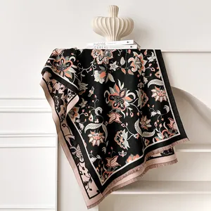 Close-up of ethnic floral jacquard scarf with fine fringe details and contrast colors
