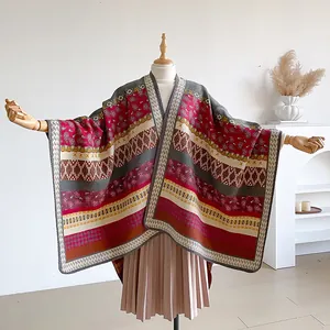 Detail of bohemian geometric paisley patterns on thick ethnic knit shawl poncho