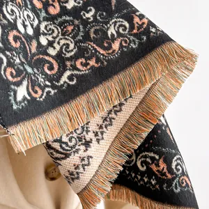 Chic paisley print scarf with multicolored tassels draped over a classic beige trench coat