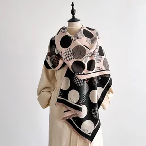 Soft cashmere-feel scarf featuring geometric polka dots and elegant tassel trim edges