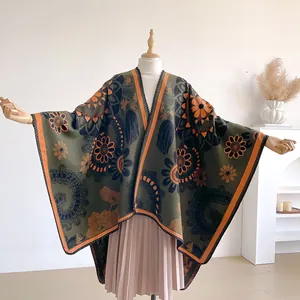 Bohemian knit poncho shawl with vintage floral patterns and orange contrast trim
