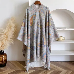 Detail of bohemian paisley shawl with soft fringe trim and ethnic v-neck knitted design