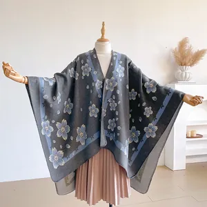 Detail of floral knit shawl edge with blue embroidery and vintage pattern texture