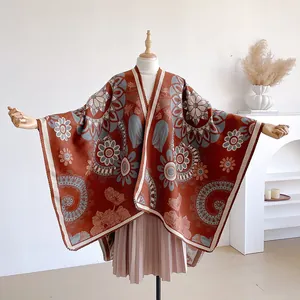 Close-up of bohemian jacquard pattern and thick knit texture on rust red shawl