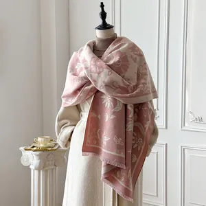 Detail of pink floral cashmere shawl with delicate fringe on an elegant mannequin