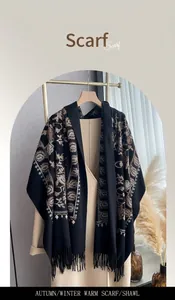 Close-up of bohemian floral embroidery and tassels on a black cashmere-feel shawl