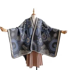 Thick bohemian jacquard shawl cape with blue floral patterns and heavy knit texture