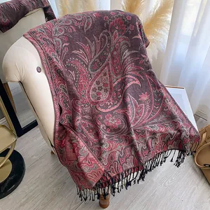 Close-up of Bohemian paisley shawl with intricate floral patterns and black tassel details