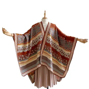 Ethnic bohemian shawl poncho with paisley geometric patterns in warm orange and grey