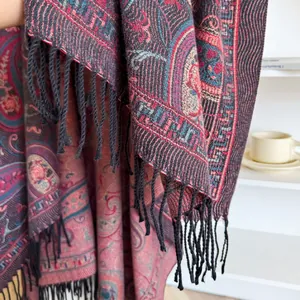 Ethnic paisley pattern cashmere blend shawl with long black tassels on a white background