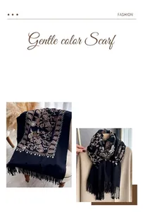 Detail of floral embroidery and fringe on black imitation cashmere scarf with soft texture