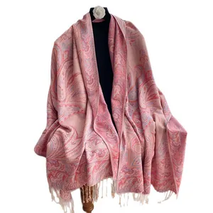 Elegant Paisley jacquard long shawl with tassel trim in pink-purple on a display mannequin