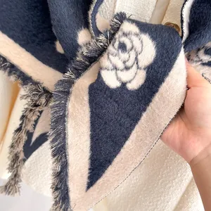 Elegant knit scarf with navy and cream stripes featuring a white camellia flower pattern