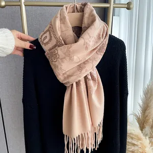 Pale pink floral embroidery cashmere scarf with delicate fringe on a black sweater