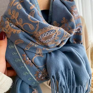 Navy blue cashmere shawl featuring elegant floral embroidery and stylish long fringes