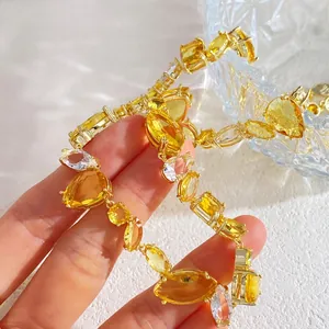 Luxuriöse goldene Halskette mit gelben und klaren Kristallen in verschiedenen Schliffen