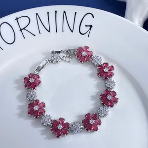 Macro detail of silver flower bracelet with pink zircon petals and sparkling crystals
