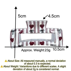 Detailed size specifications for hair claw clip featuring black stripes and red glitter hearts